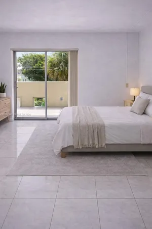 a bedroom with a bed and a large window