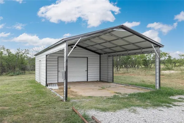 a view of entryway kitchen and hall with wooden floor