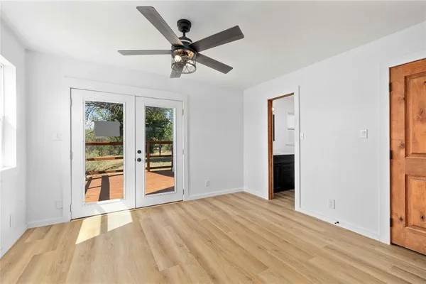 a kitchen with wooden floors and wide window