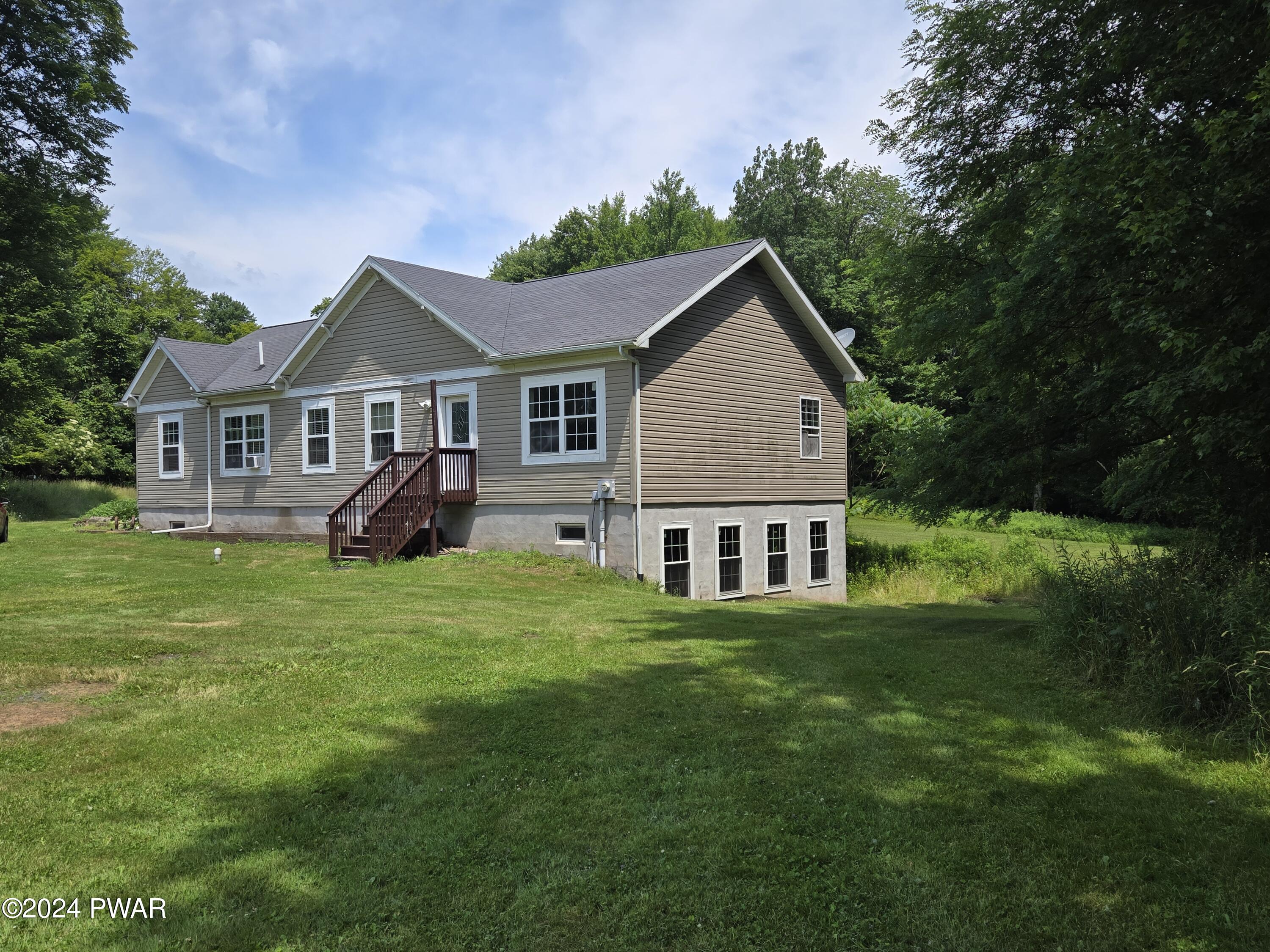224 Old Racht Road Waymart, PA 18472 - Photo 1 of 39 a view of a house with a big yard potted plants and large tree