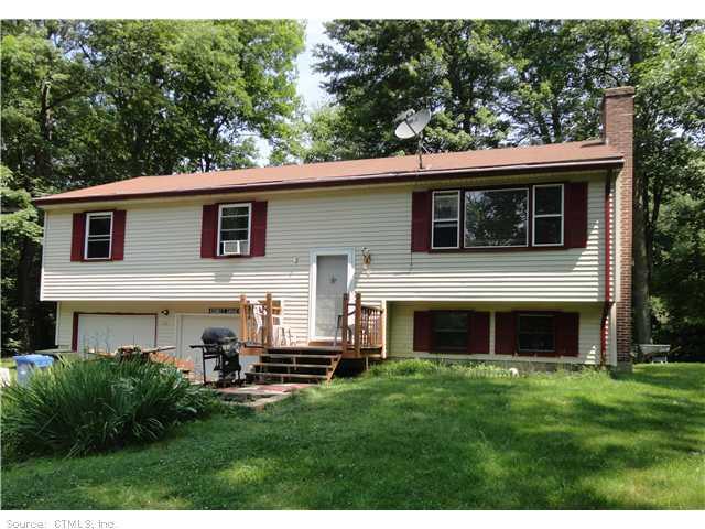 46 Gehring Rd Extension Tolland, CT 06084 - Photo 1 of 1 a front view of a house with a garden and yard