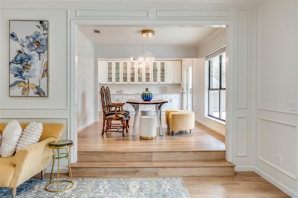 9130 Valley Chapel Lane Dallas, TX 75220 - Photo 13 of 39 a dining room with wooden floor and white walls