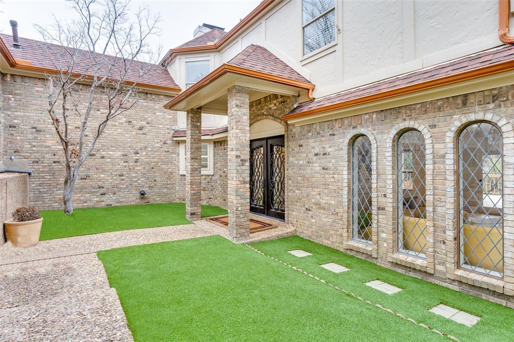 9130 Valley Chapel Lane Dallas, TX 75220 - Photo 2 of 39 a front view of a house with a garden
