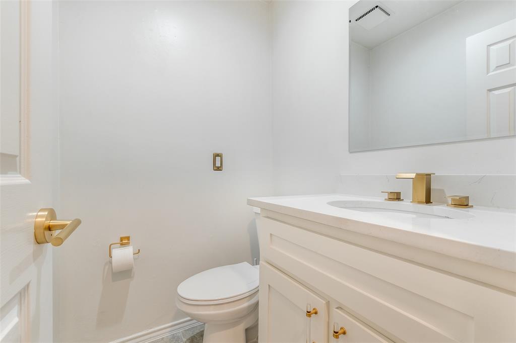 9130 Valley Chapel Lane Dallas, TX 75220 - Photo 21 of 39 a bathroom with a sink a toilet and a vanity