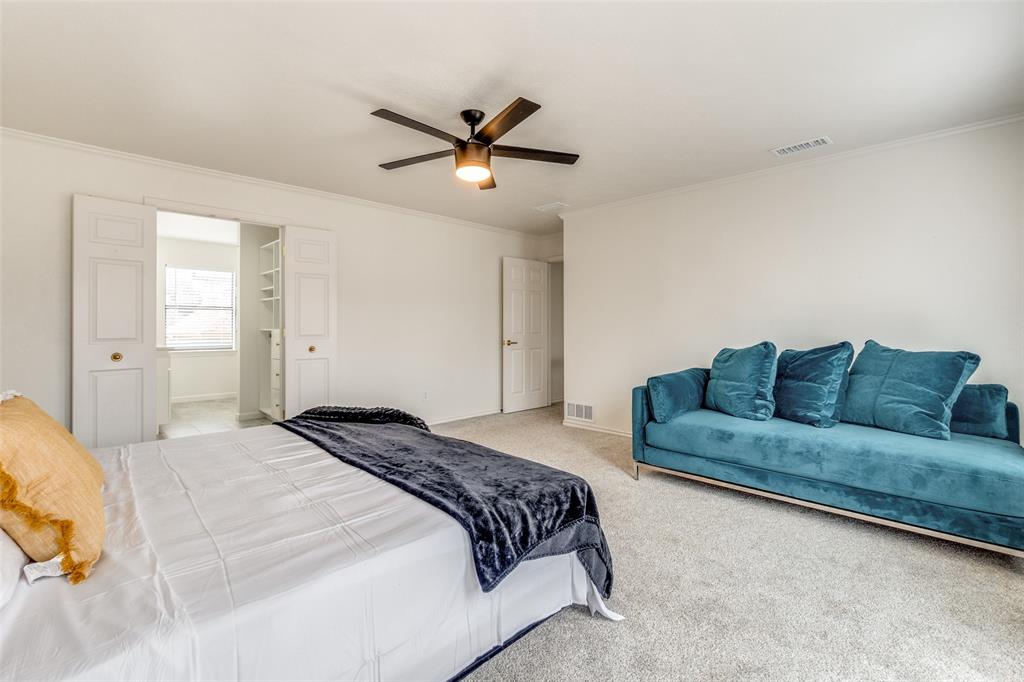 9130 Valley Chapel Lane Dallas, TX 75220 - Photo 23 of 39 a spacious bedroom with a bed and a ceiling fan