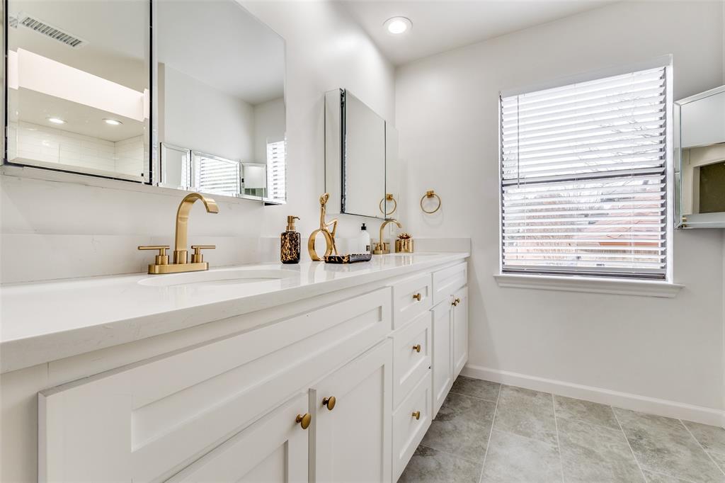 9130 Valley Chapel Lane Dallas, TX 75220 - Photo 24 of 39 a bathroom with double vanity sink a mirror and a shower