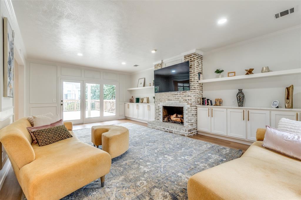 9130 Valley Chapel Lane Dallas, TX 75220 - Photo 7 of 39 a living room with furniture a fireplace and a flat screen tv