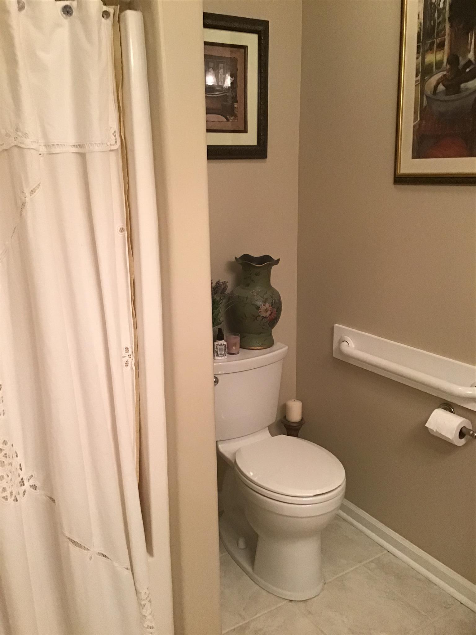 1108 Paris Avenue Nashville, TN 37204 - Photo 8 of 30 a white toilet sitting next to a small sink