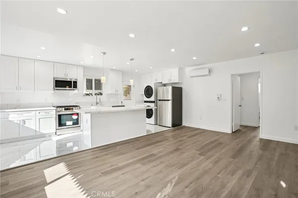 a kitchen with stainless steel appliances refrigerator sink and microwave