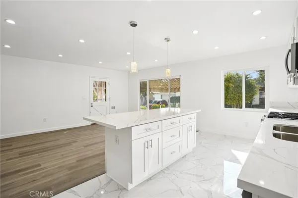 a large white kitchen with a large window