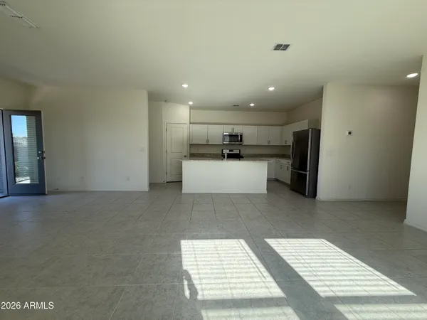 a view of a kitchen with a sink and a refrigerator