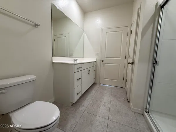 a bathroom with a toilet a sink and shower