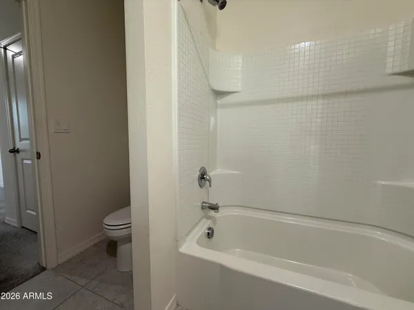 a bathroom with a bathtub and a toilet