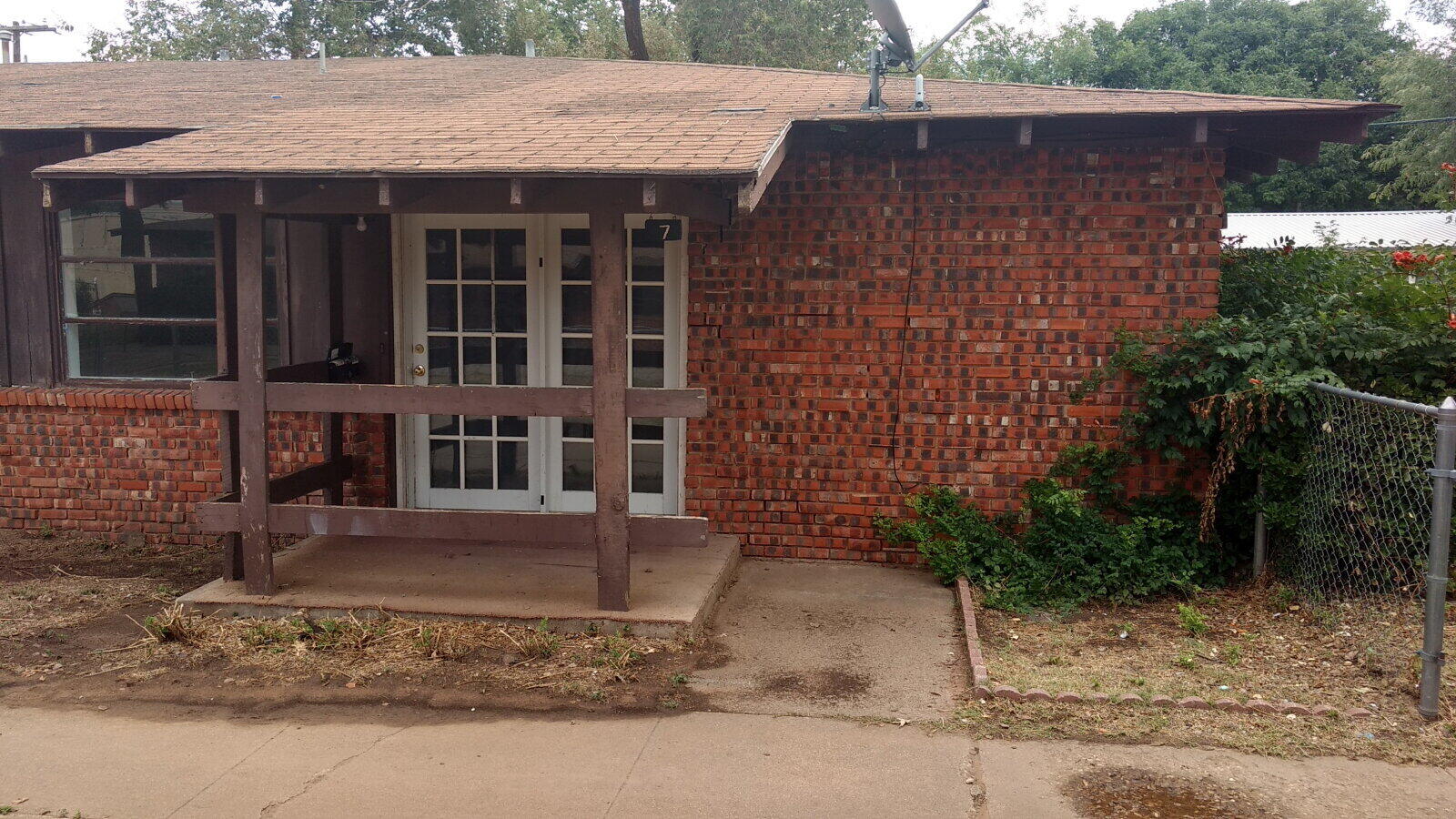 2812 43rd Street, Unit 7 Lubbock, TX 79413 - Photo 1 of 5 a front view of a house with a yard