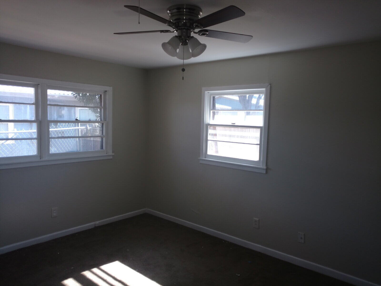 2812 43rd Street, Unit 7 Lubbock, TX 79413 - Photo 3 of 5 an empty room with a window and a fan