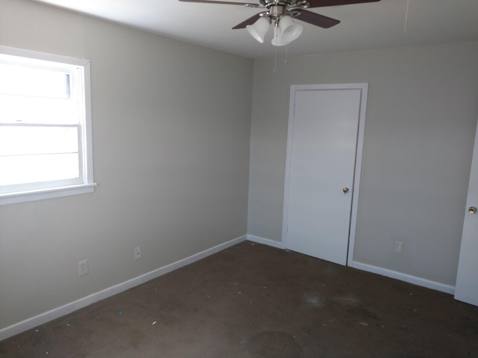 2812 43rd Street, Unit 7 Lubbock, TX 79413 - Photo 5 of 5 an empty room with a chandelier fan and windows
