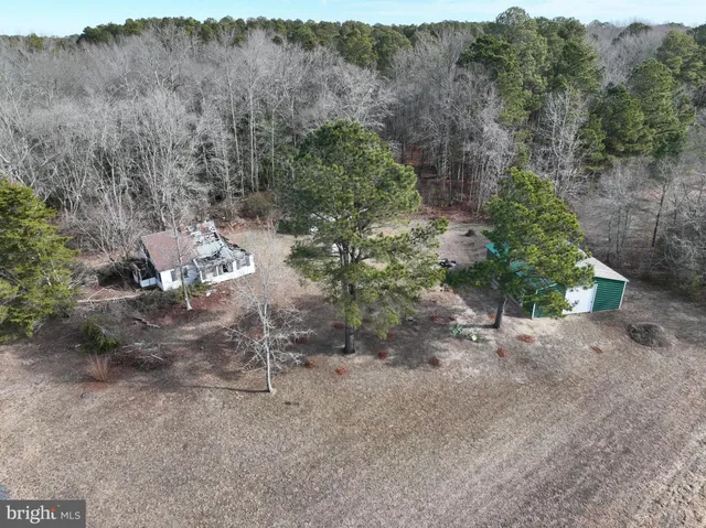 a backyard of a house with a yard and outdoor seating