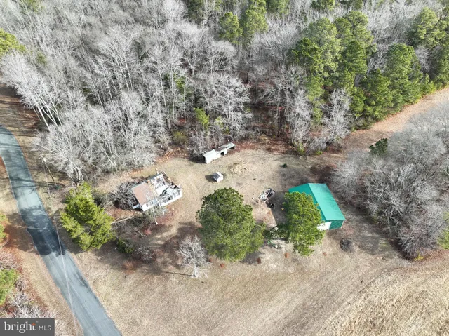 a view of a house with yard and sitting area