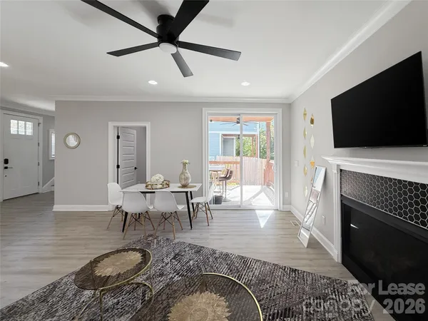 a living room with furniture a flat screen tv and a fireplace