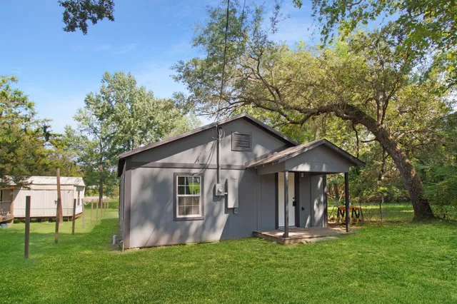 a front view of a house with a yard and porch