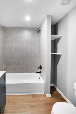 a bathroom with a bathtub and shower