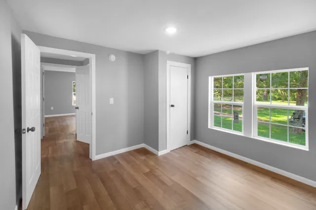 wooden floor in an empty room with a window