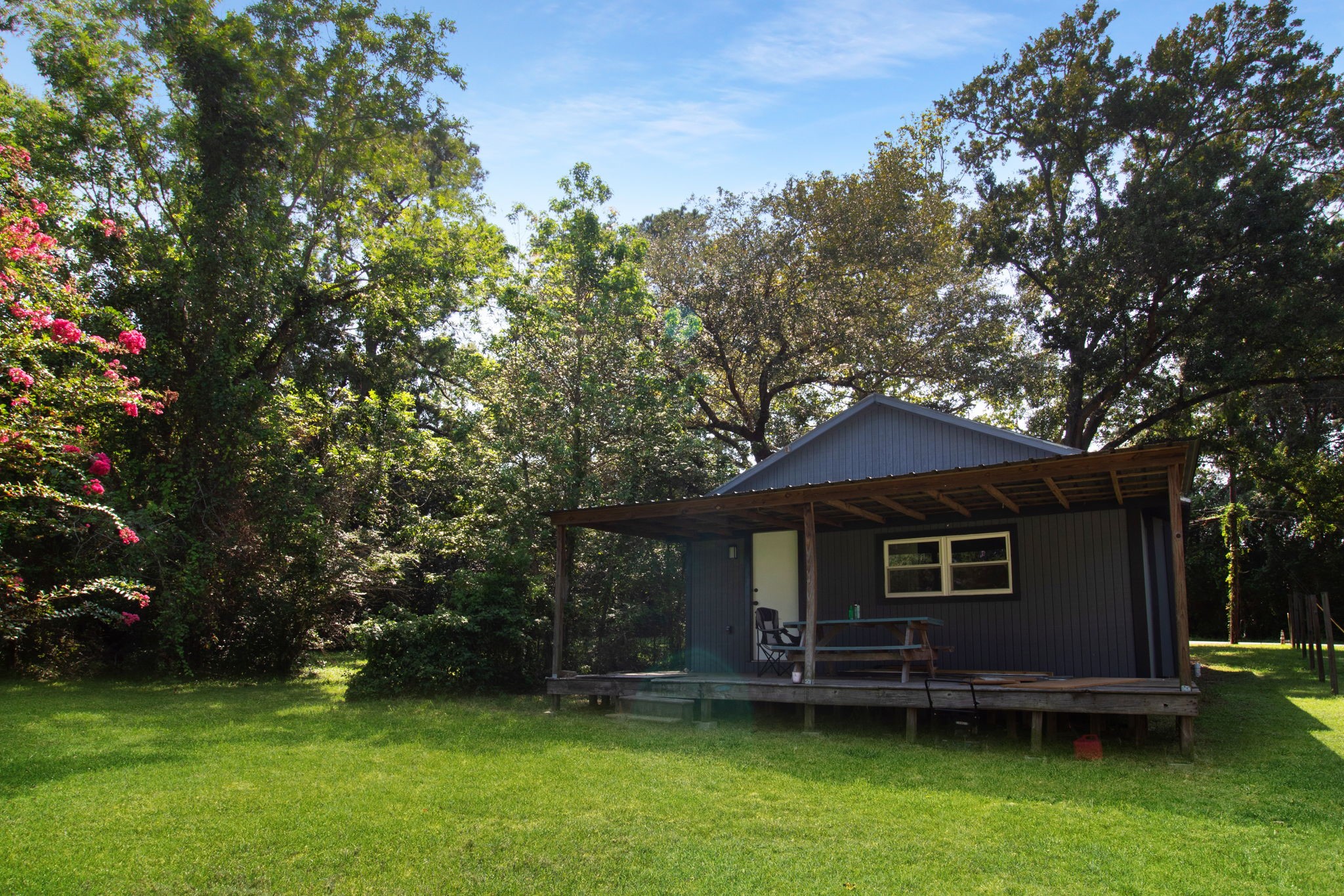 231 Page Avenue Shepherd, TX 77371 - Photo 14 of 14 a front view of a house with a garden