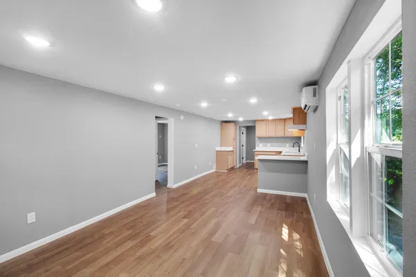 a view of kitchen with wooden floor and electronic appliances