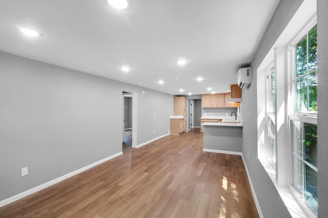 a view of kitchen with wooden floor and electronic appliances