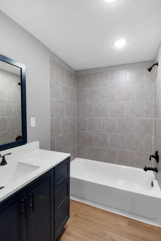 a bathroom with a bathtub and a sink