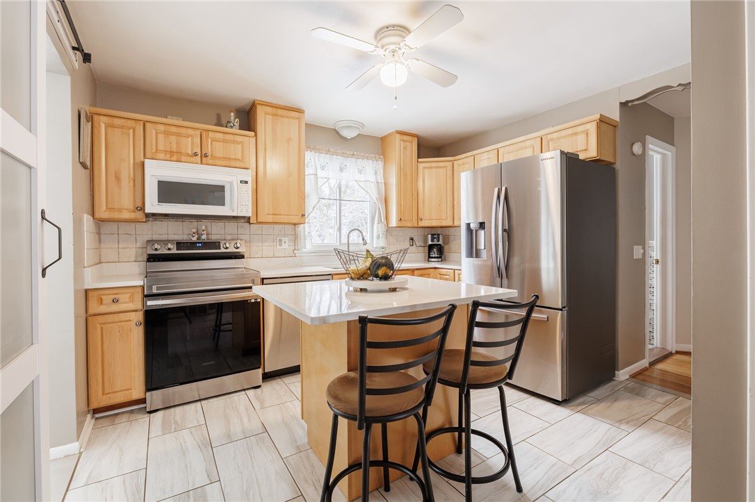 1572 Scribner Road Penfield, NY 14526 - Photo 12 of 32 Kitchen with new stainless oven/range, fridge and