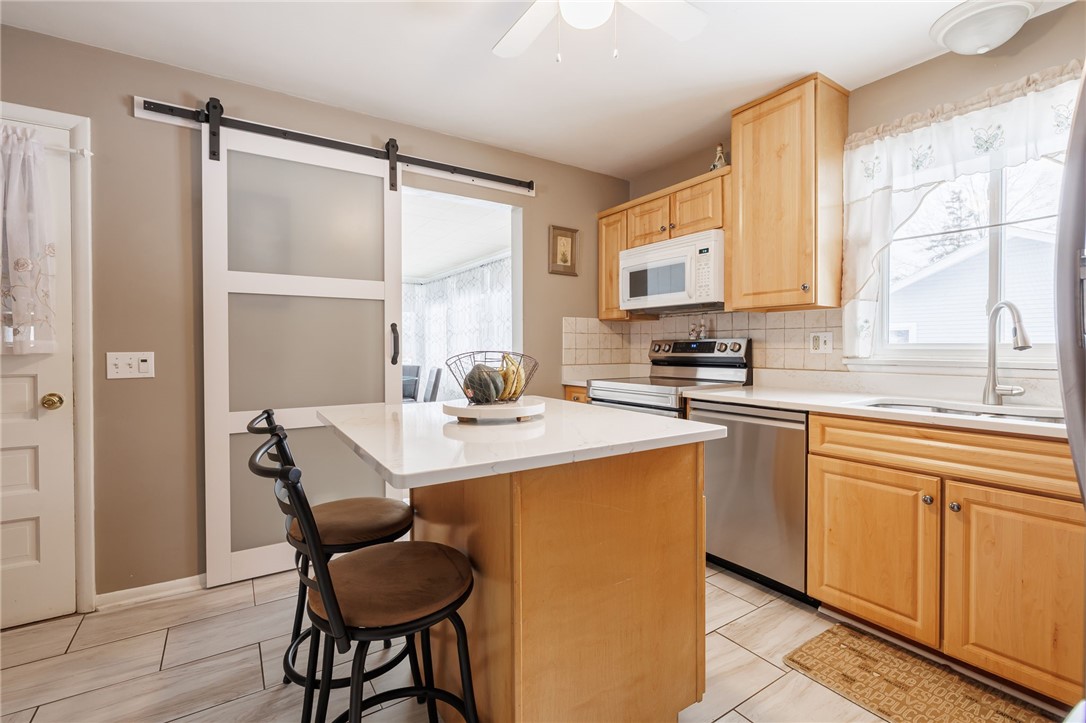 1572 Scribner Road Penfield, NY 14526 - Photo 13 of 32 Kitchen with quartz countertops.