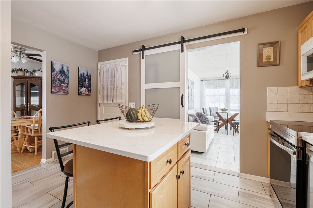 1572 Scribner Road Penfield, NY 14526 - Photo 14 of 32 Kitchen looking toward bonus room/sunroom.