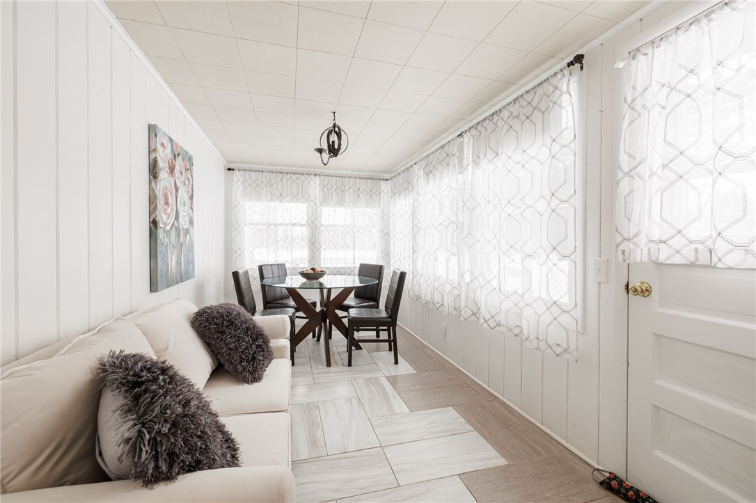 1572 Scribner Road Penfield, NY 14526 - Photo 16 of 32 Sunroom filled with light offers many options.