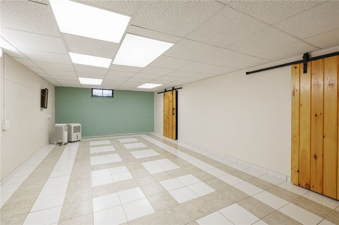 1572 Scribner Road Penfield, NY 14526 - Photo 25 of 32 Finished basement space view from stairs