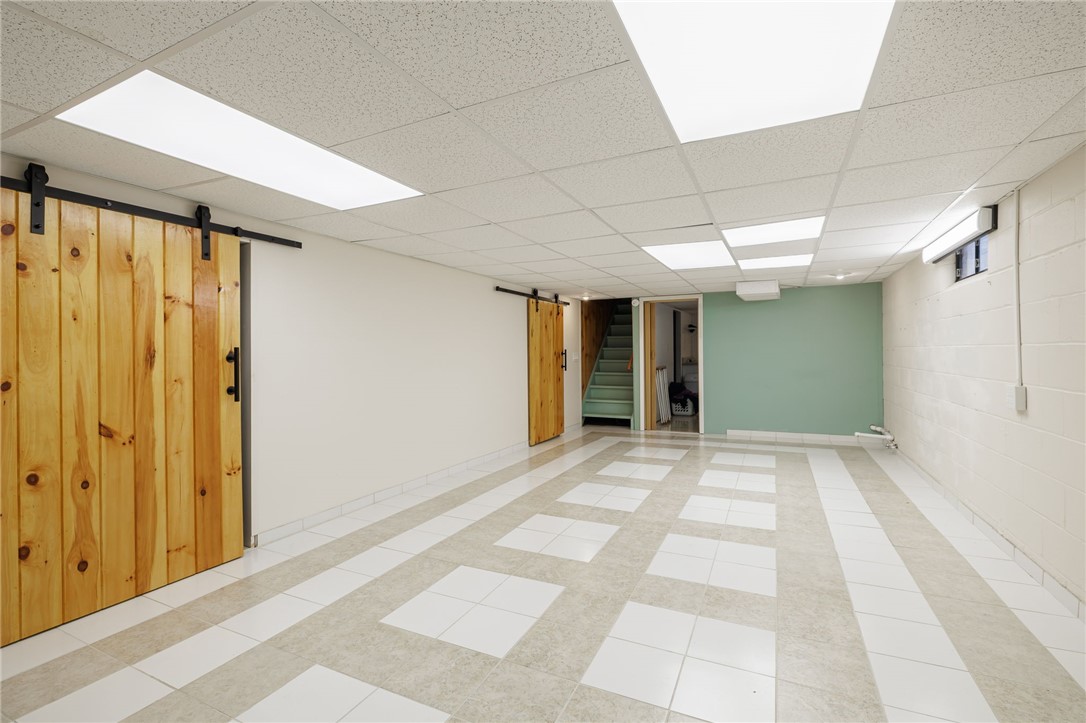 1572 Scribner Road Penfield, NY 14526 - Photo 27 of 32 Finished basement space looking toward stairs