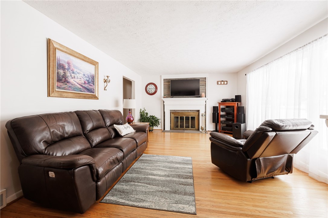 1572 Scribner Road Penfield, NY 14526 - Photo 7 of 32 Livingroom showcasing fireplace (as-is, never used