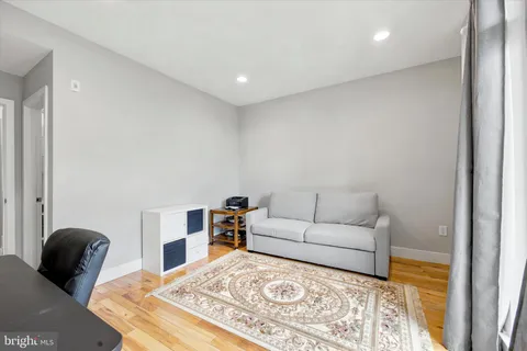 a living room with furniture and a lamp