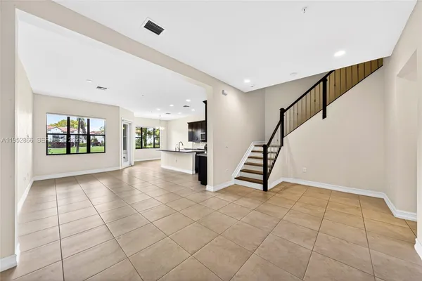 a view of an entryway with stairs and a living room