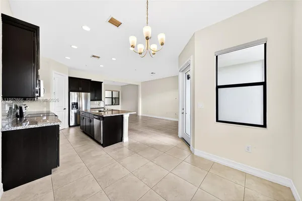 a living room with kitchen island furniture and a flat screen tv