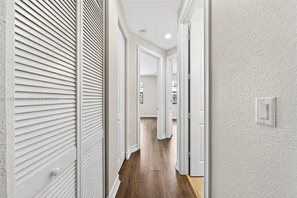 a view of a hallway with wooden floor