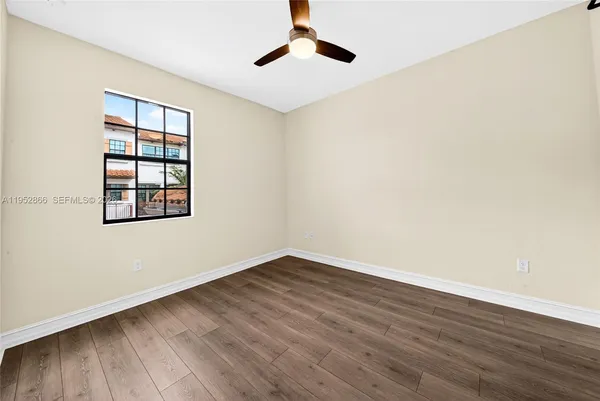 wooden floor in an empty room with a window