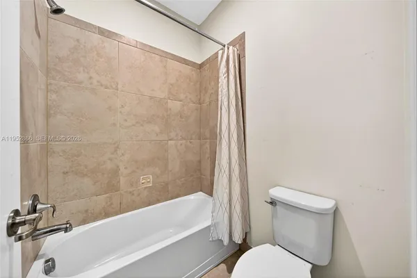 a bathroom with a toilet and a bathtub