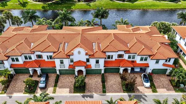 an aerial view of multiple houses with a yard