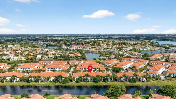 an aerial view of residential building and lake