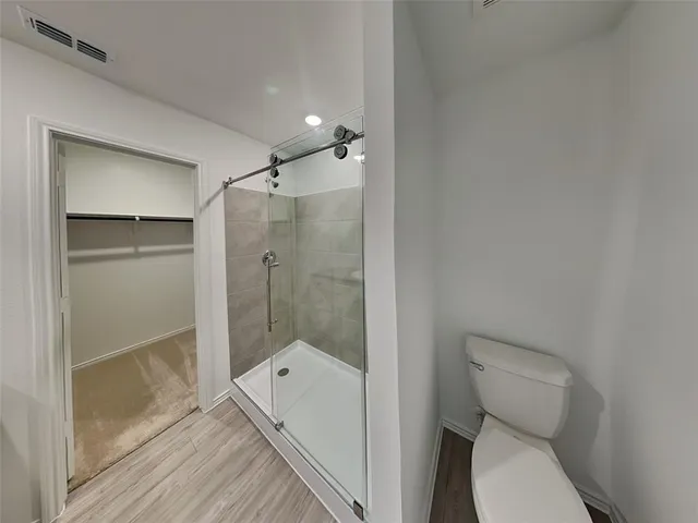 a bathroom with a toilet and a shower