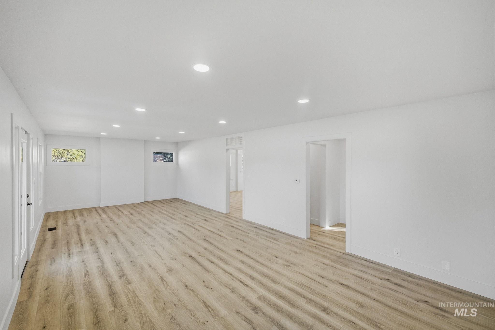 3113 West Overland Road Boise, ID 83705 - Photo 23 of 40 Spacious interior with neutral wall tones, recessed lighting, wood-finish flooring, and multiple windows