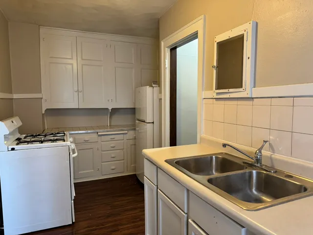 a view of room with wooden floor