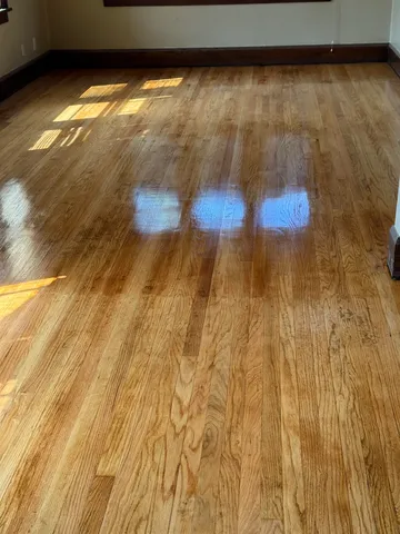 a kitchen with a sink a stove and wooden floor