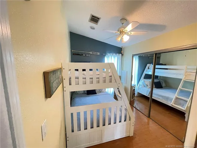 a bedroom with furniture and wooden floor